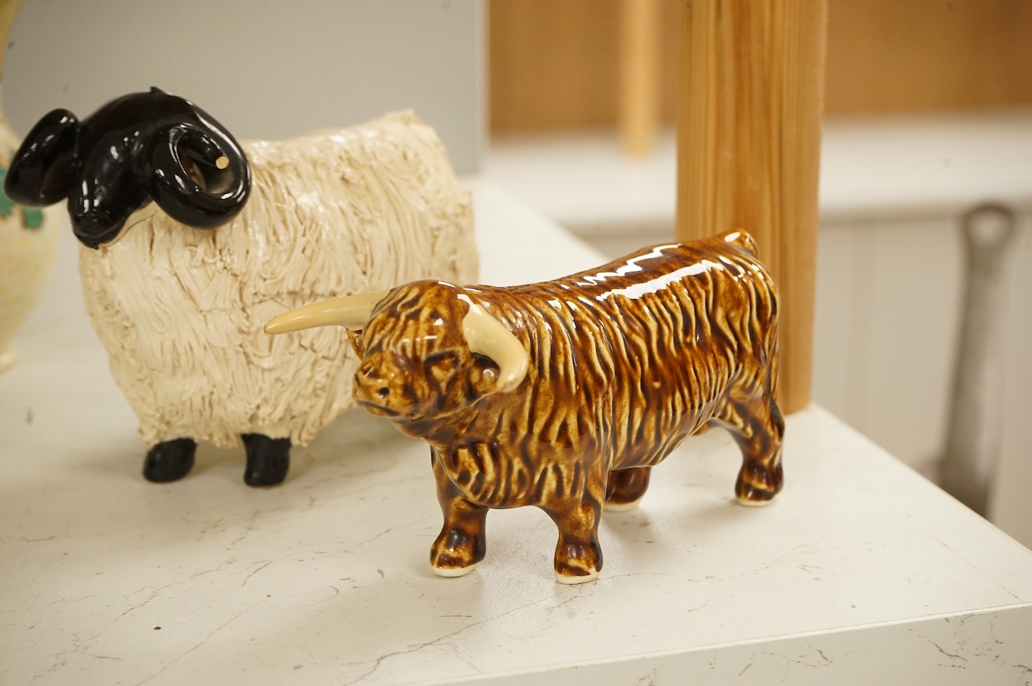 A Roy Smith Wedgwood polar bear, Poole pottery badger, Beswick bull and pig, together with other collectables, largest 17cm high